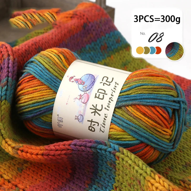 A close-up of three balls of gradient acrylic yarn in various colors, bundled together for knitting or crochet projects.
