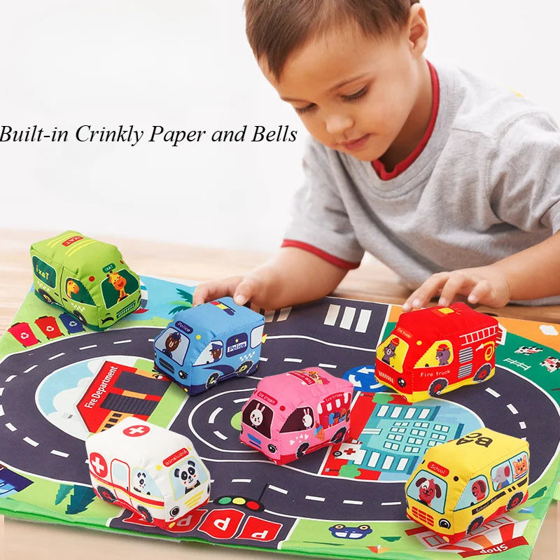 A child plays with a soft fabric car toy set featuring a map game mat and storage bag.