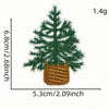 A green pine tree patch with a woven brown basket attached, measuring 6.8cm high and 5.3cm wide.