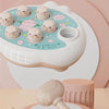 A white and pink round design toy featuring pig-shaped silicone molds for toddlers.