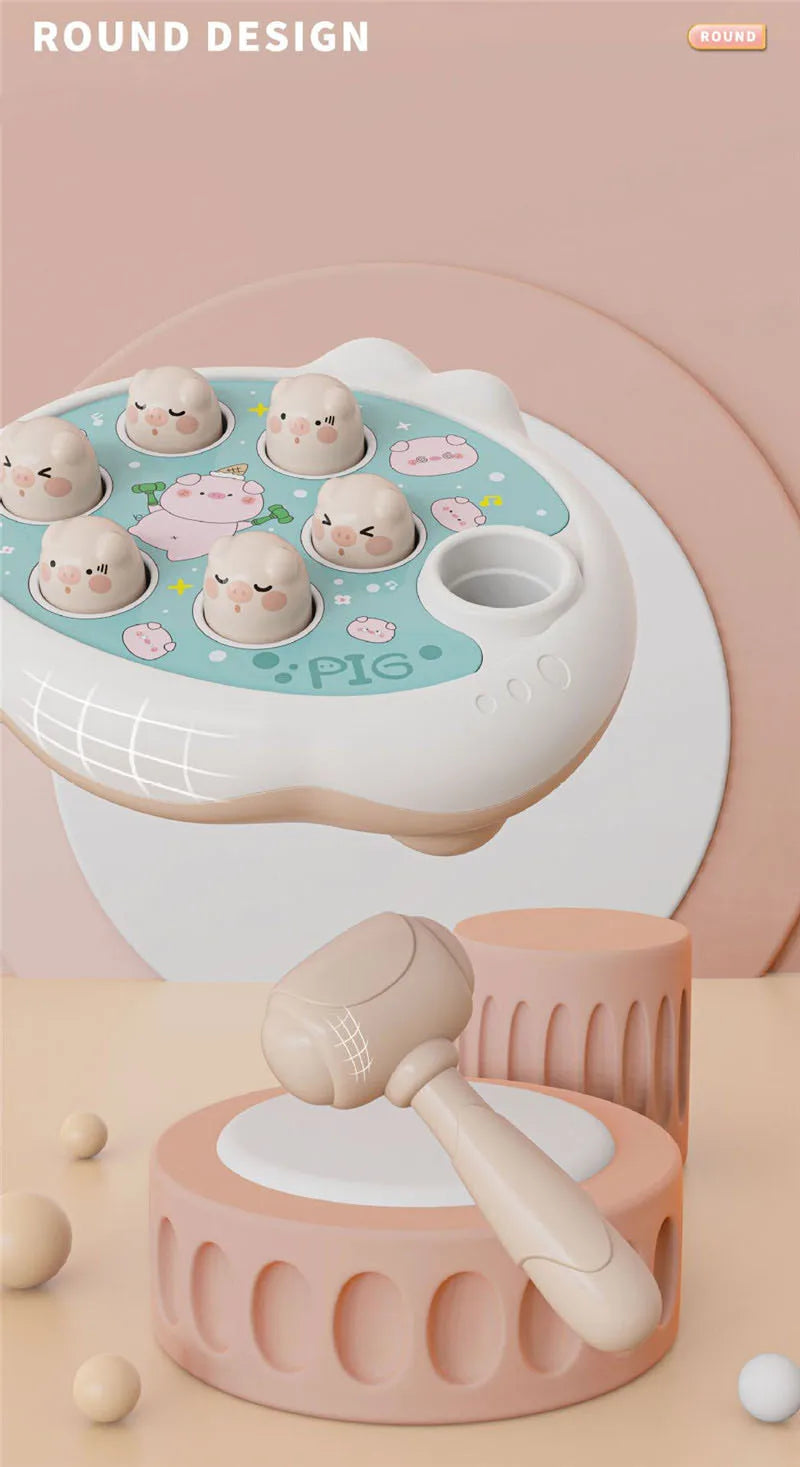 A white and pink round design toy featuring pig-shaped silicone molds for toddlers.