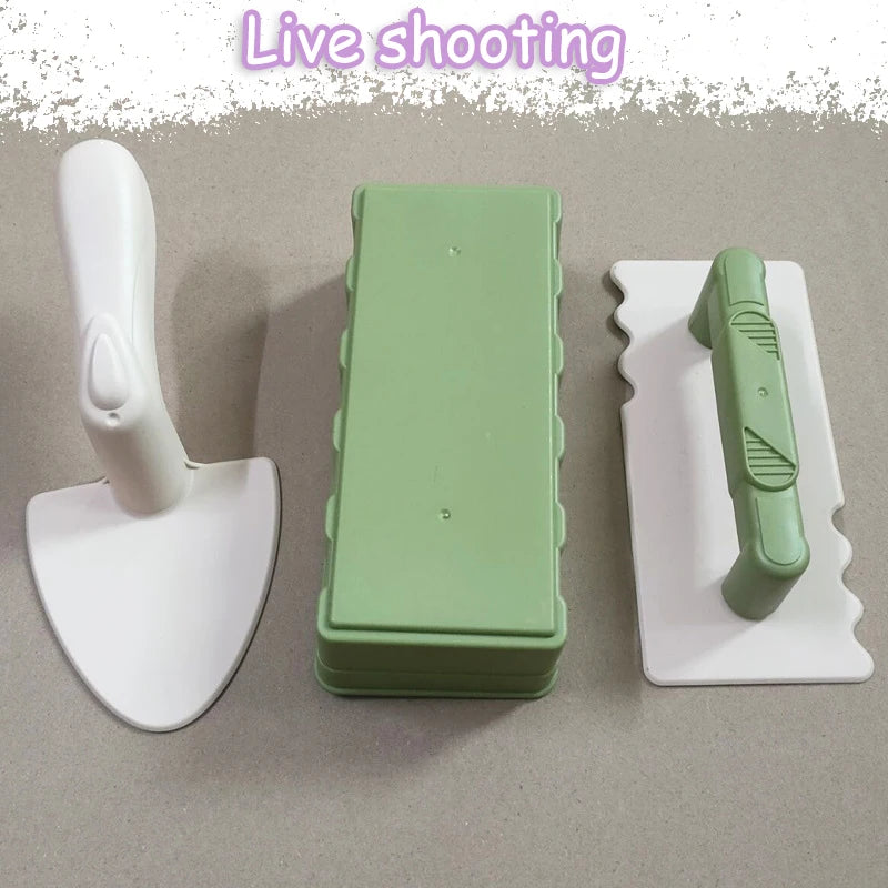 A set of green and white beach sand castle building tools including a shovel and a mold