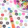 Assortment of colorful acrylic spacer beads in various shapes and colors scattered on a white surface.