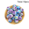 A pile of ten iridescent purple and blue printed silicone beads for DIY jewelry making