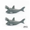 Two gray plastic marine animal building blocks, including a shark and an octopus.