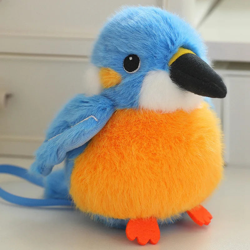 A fluffy blue and orange cartoon bird plush with a black beak and blue tail.