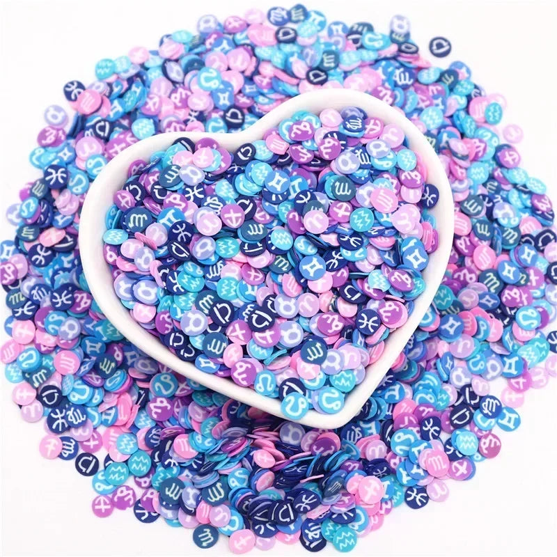 A heart-shaped mound of colorful polymer clay sprinkles in shades of purple, blue, and pink.