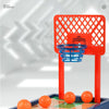 An orange mini basketball hoop and court setup for a tabletop arcade game.