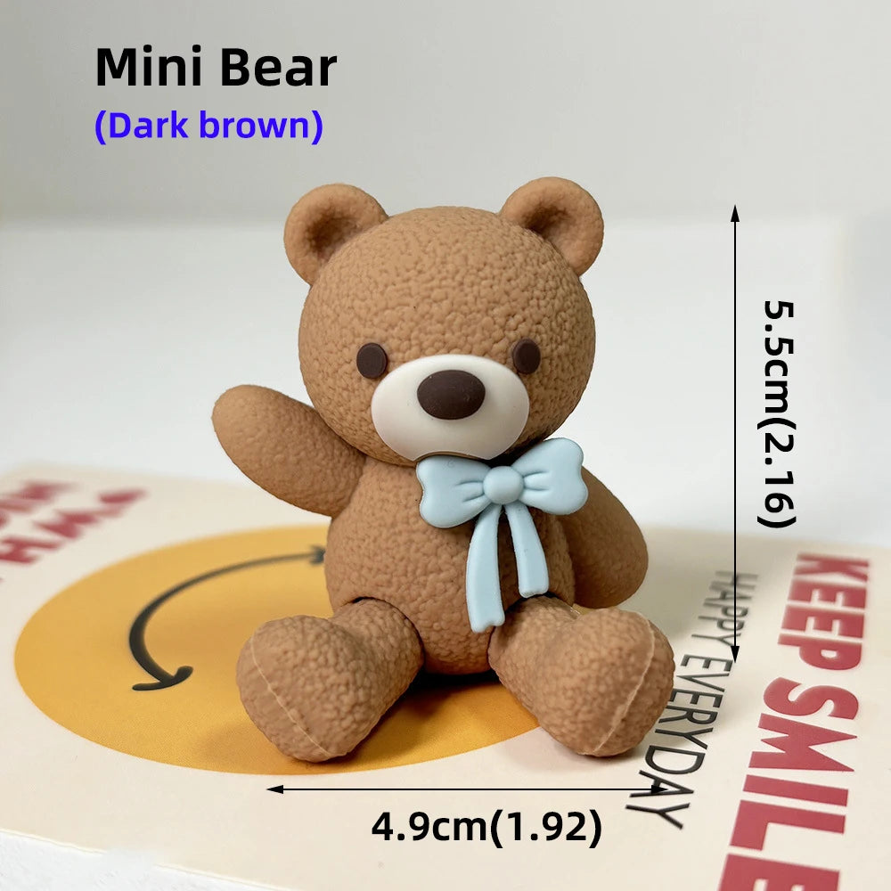 A dark brown Mini Bear teddy bear figure standing on a cake base.