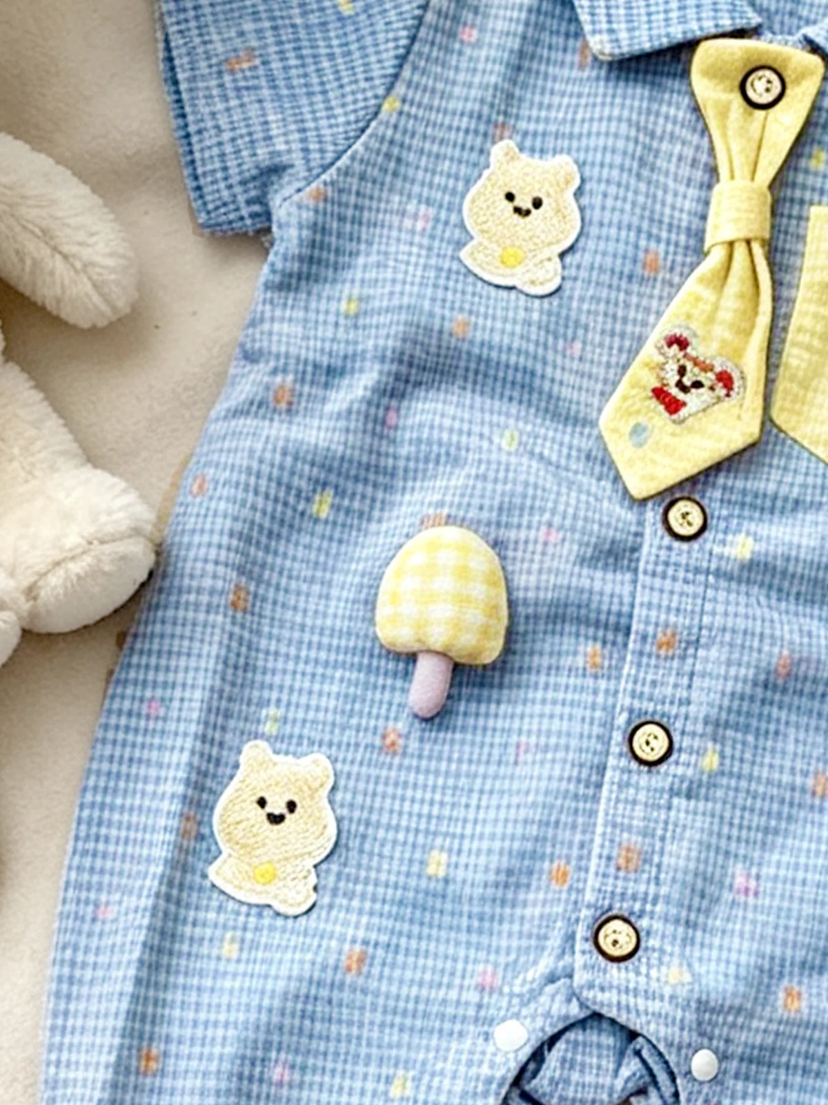 Light blue baby boy short-sleeve romper with yellow bear and mushroom appliqués