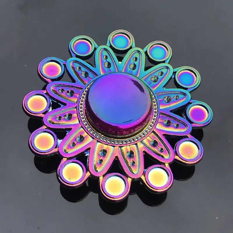 A colorful metal fidget spinner with a purple and blue flower design.