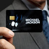 A hand holds a black credit card with the name Michael Jackson printed on it against a starry background.