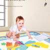 A child is playing on a large magic water drawing mat filled with colorful shapes and pens.