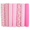 A pack of seven rolls of pink and white striped cotton fabric squares for quilting and patchwork