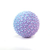A spherical, textured fidget roller keychain with a purple-blue iridescent finish.