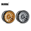 A pair of black and gold beadlock wheels for an RC car, featuring a silver spoke design.