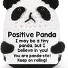 A white and black crocheted panda doll with a supportive message card.