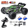 A green and black brushless 4WD monster truck RC car with large tires and accessories.
