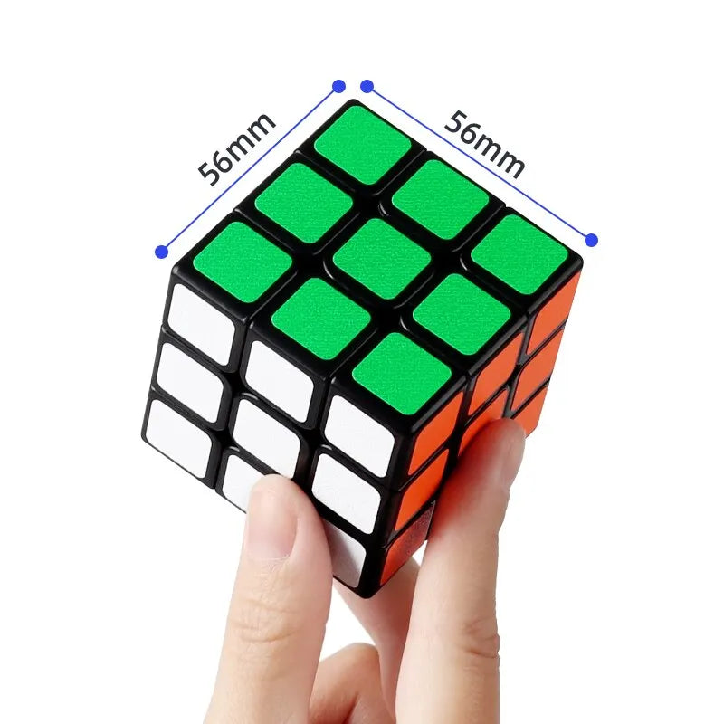 A hand is holding a green and orange frosted 3x3 magic cube puzzle with measurement lines indicating its size.
