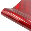 A close-up view of a red glitter heat transfer vinyl roll being rolled.