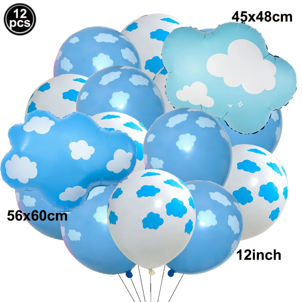 A bunch of blue and white foil balloons shaped like clouds and planes for birthday party decor