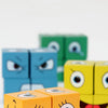 A close-up of wooden face-changing puzzle cubes in various colors like blue, green, and yellow.
