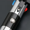 A close-up view of a Darth Vader Neopixel lightsaber with a black and silver hilt and red accents.