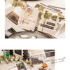 A collection of scrapbook stickers and paper elements laid out on a white surface for DIY crafts.