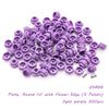 A pile of light purple round plates with flower edges used for building blocks.