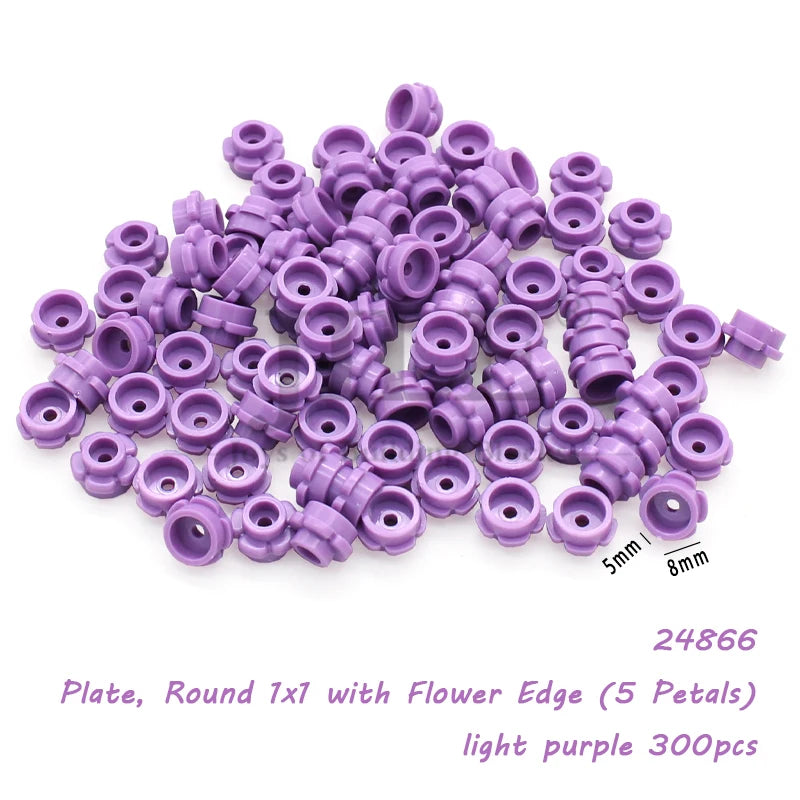 A pile of light purple round plates with flower edges used for building blocks.