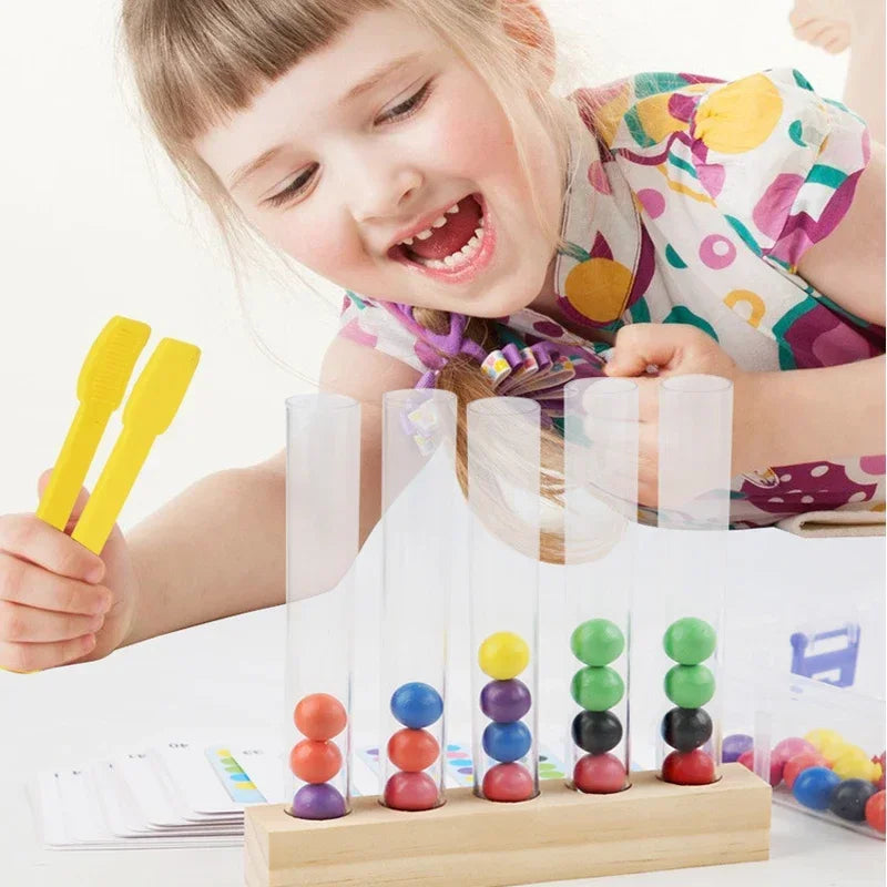 A young girl is using wooden clip beads in clear test tubes for a fine motor skills game.