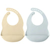 A pair of light beige and light blue waterproof silicone baby bibs with adjustable necks.