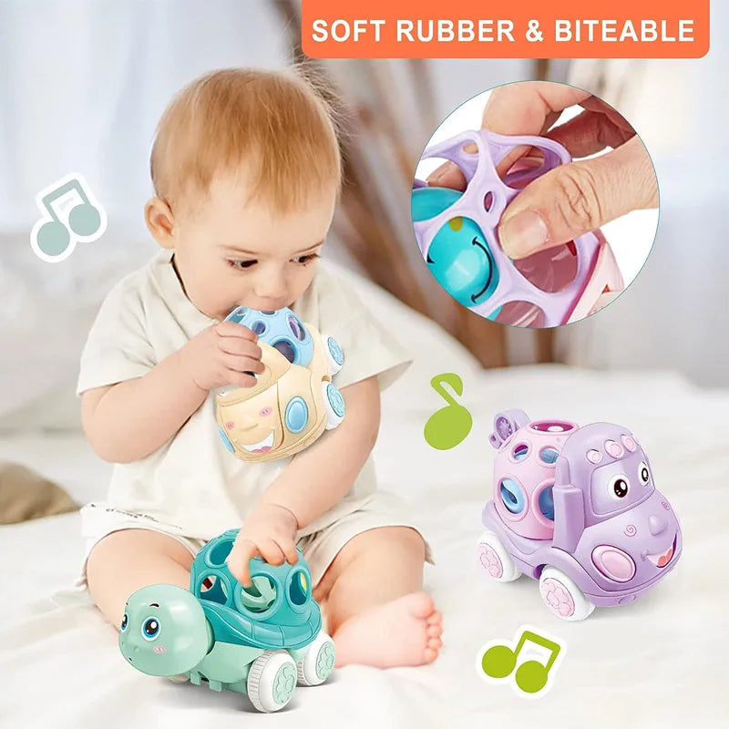 A baby is playing with soft rubber push and go friction cars and a rattle toy set.