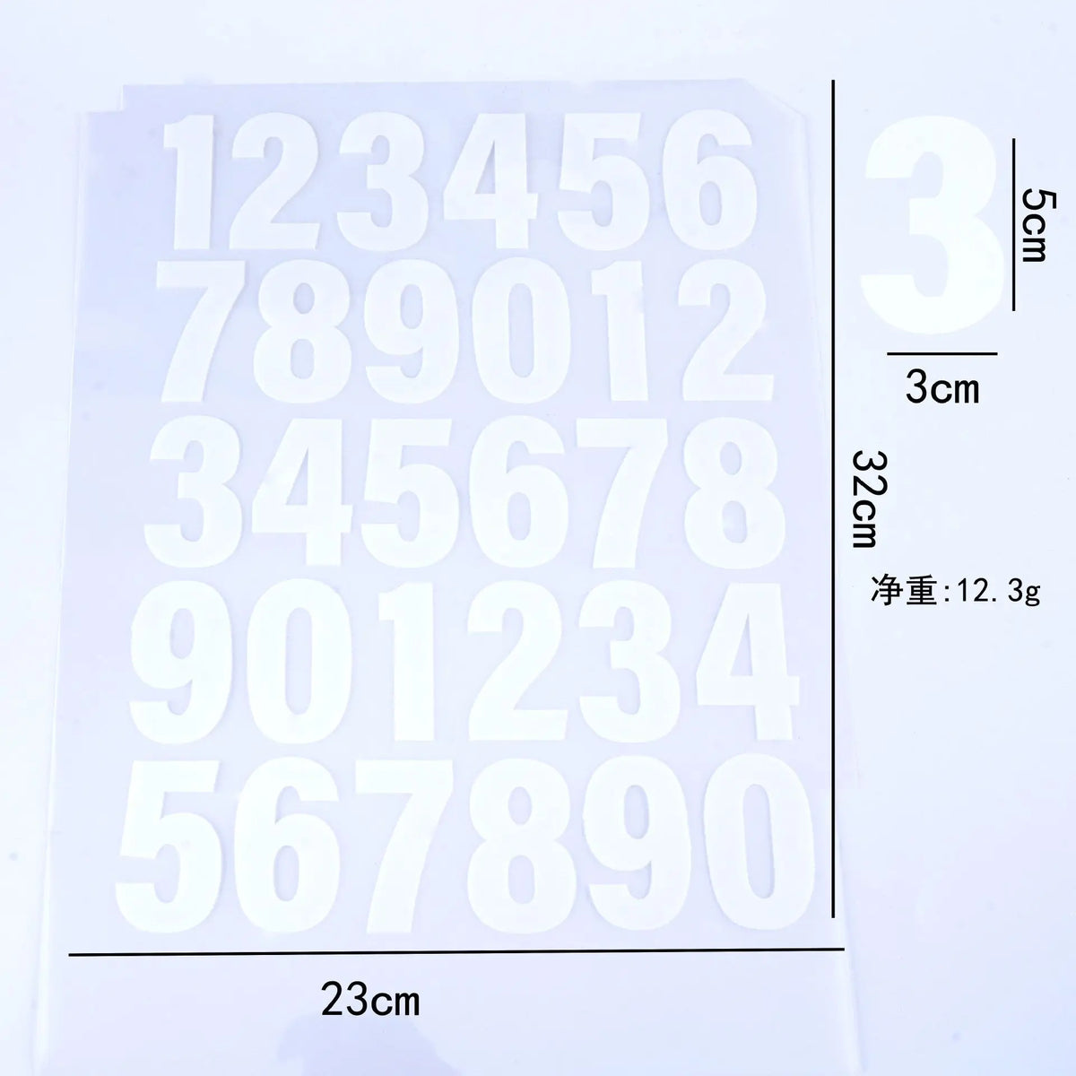 A sheet of DIY iron-on heat transfer patches showing a grid of numbers and text with a scale marker.