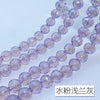 A close-up of a strand of light purple crystal beads with an AB coating, showing the texture and clarity.
