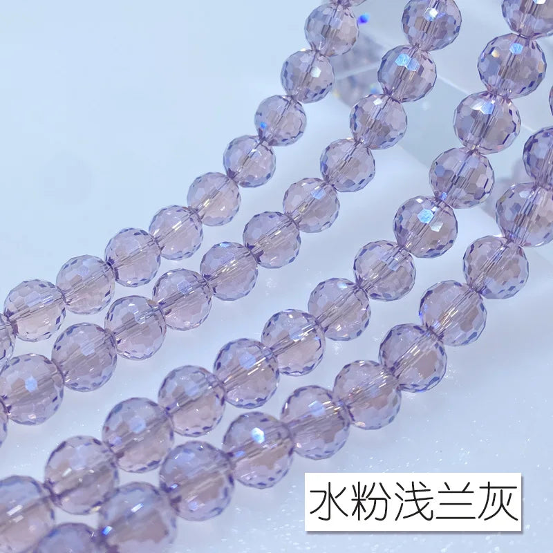 A close-up of a strand of light purple crystal beads with an AB coating, showing the texture and clarity.