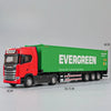 A red Scania truck model with a green container labeled EVERGREEN on a display stand.