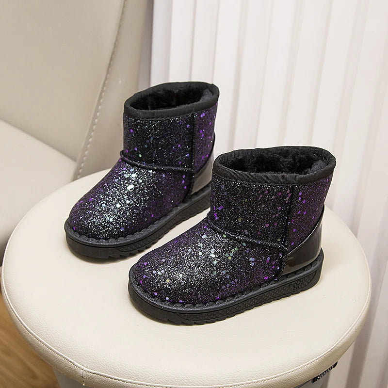 A pair of purple glitter snow boots with faux fur lining displayed on a white surface.