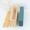 A silicone rectangle soap mold is shown with a wooden box and lid, featuring light wood and teal accents.