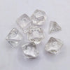 A collection of ten clear acrylic polyhedral dice showing various numbers and shapes for tabletop gaming.