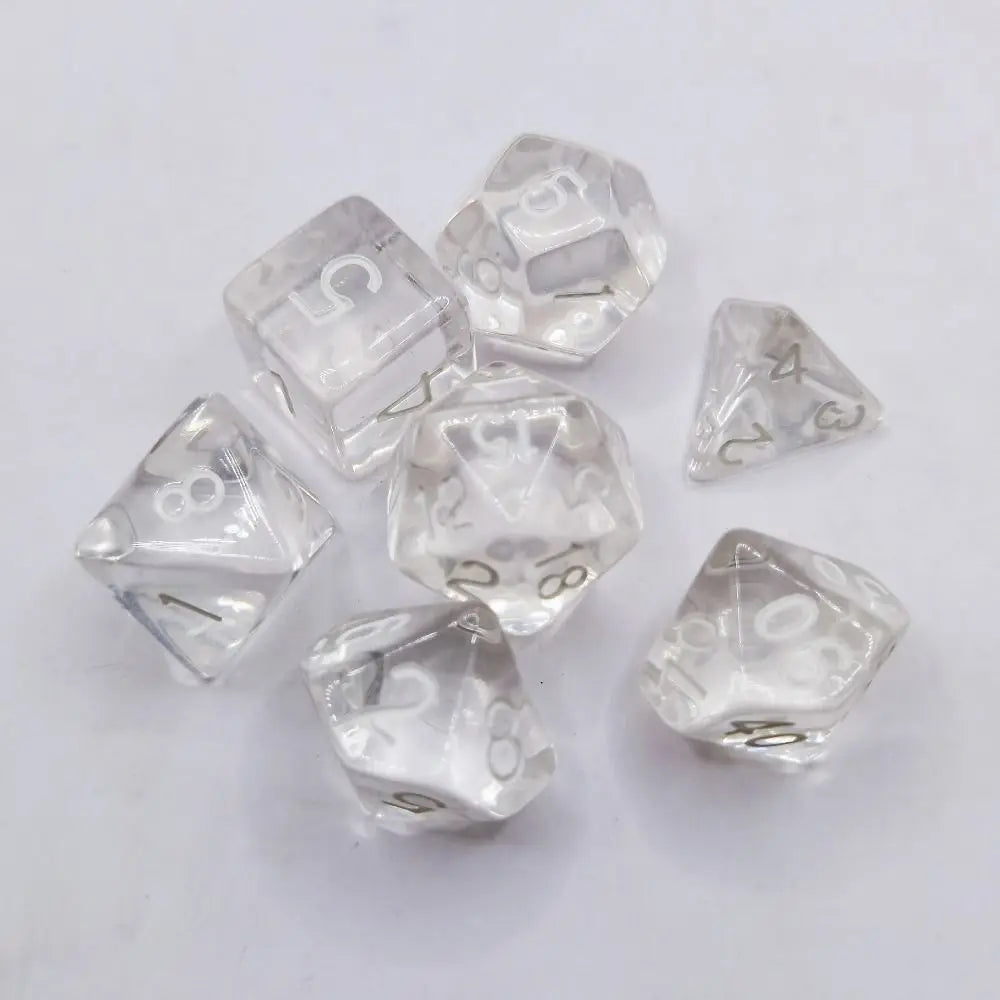 A collection of ten clear acrylic polyhedral dice showing various numbers and shapes for tabletop gaming.