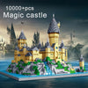 A large yellow magic castle built from LEGO bricks on an island with green landscaping and blue water.