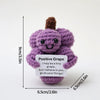 A handmade crochet pocket hug doll in purple with a brown top, featuring an inspirational slogan.