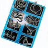 A blue plastic tray holding eight metal brain teaser puzzle pieces.