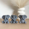 Three gray elephant silicone molds for candles soap and resin crafts displayed on a light brown surface.
