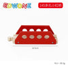 A red wooden train track accessory featuring a platform with multiple circular holes.