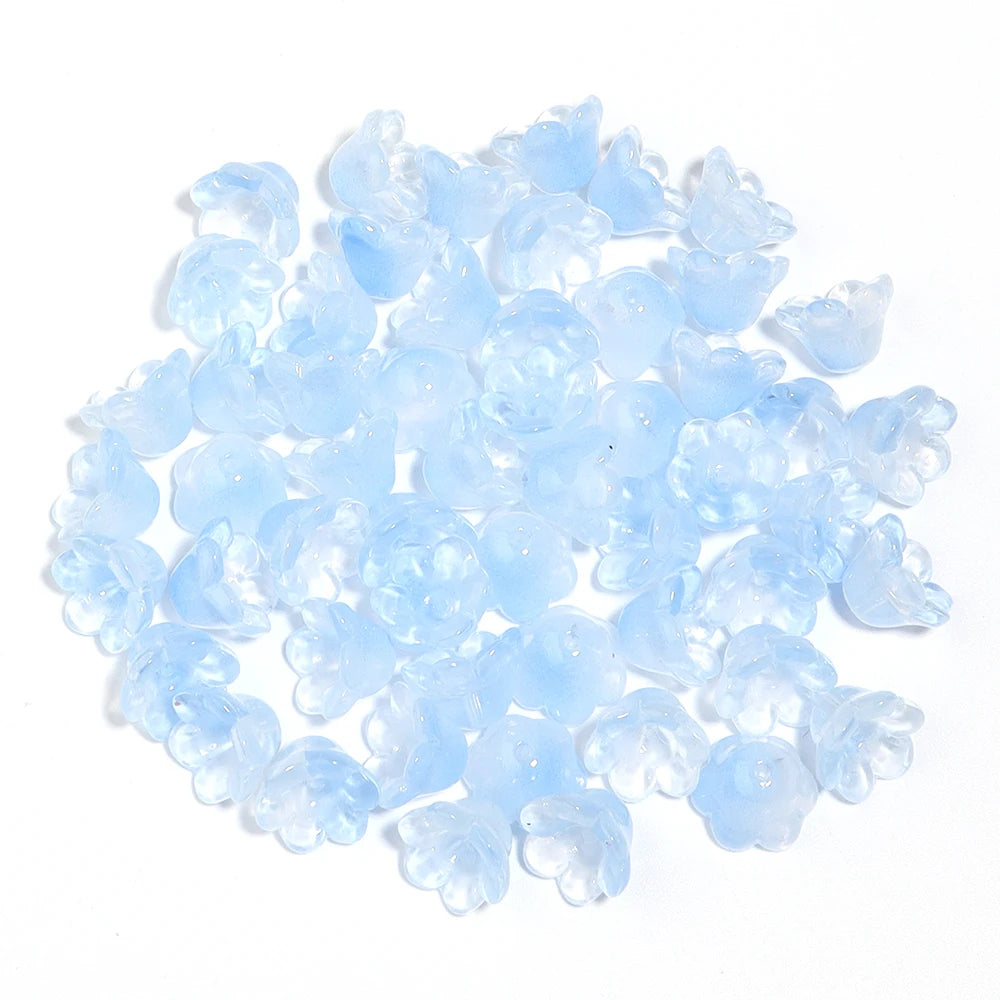 A pile of 50 clear light blue cherry blossom flower glass beads for jewelry making