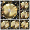 A set of five brass pentagram altar plates with ritual parchments displayed on a dark surface.