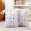 A set of two reusable waterproof baby wet bags featuring a repeating pattern of safari animals and foliage on a white backgro