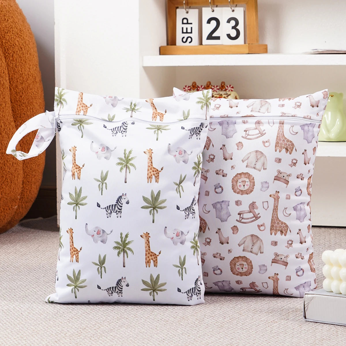 A set of two reusable waterproof baby wet bags featuring a repeating pattern of safari animals and foliage on a white backgro